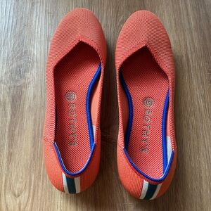 Rothy’s The Flat Tangerine/Orange with Navy. Size 9
